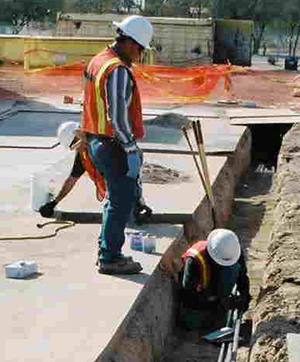 trench-install BELFOR Environmental technicians work on a trench install