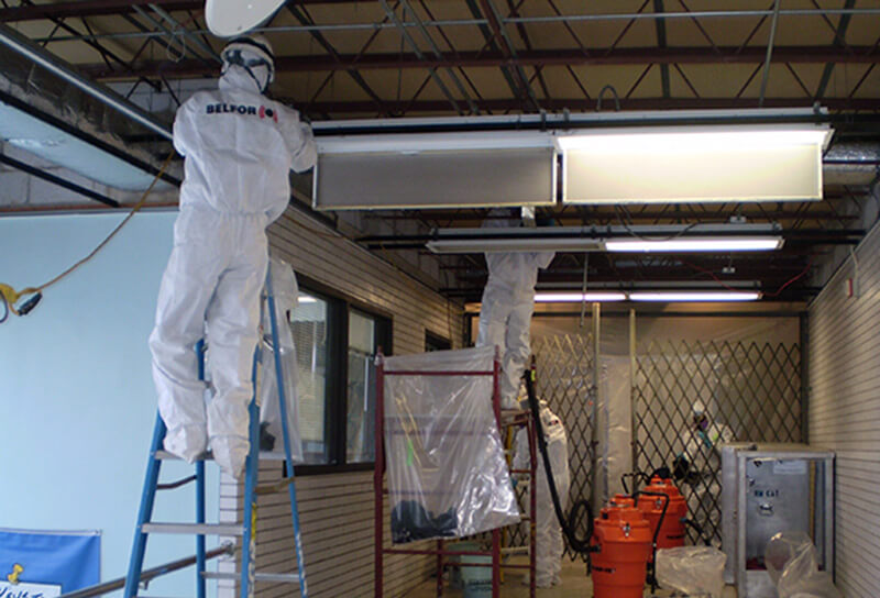 BELFOR removing asbestos from ceiling