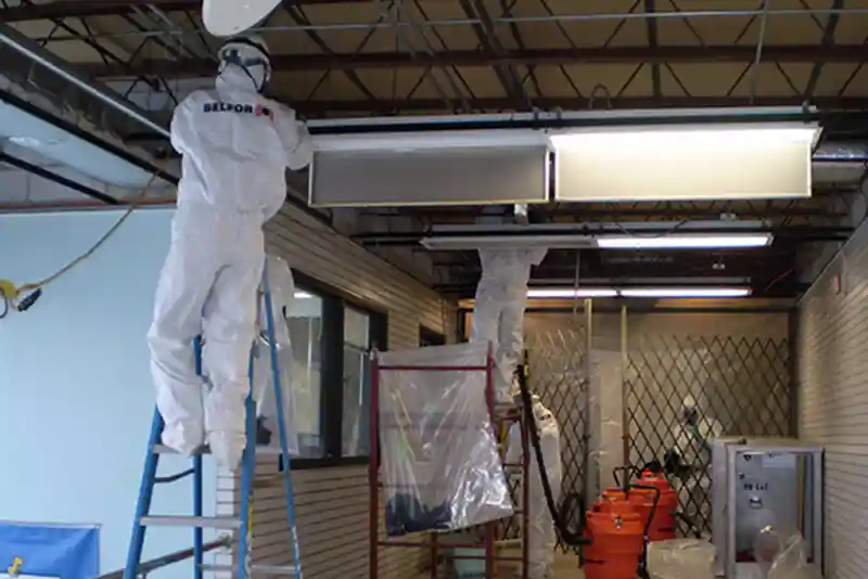 BELFOR removing asbestos from ceiling